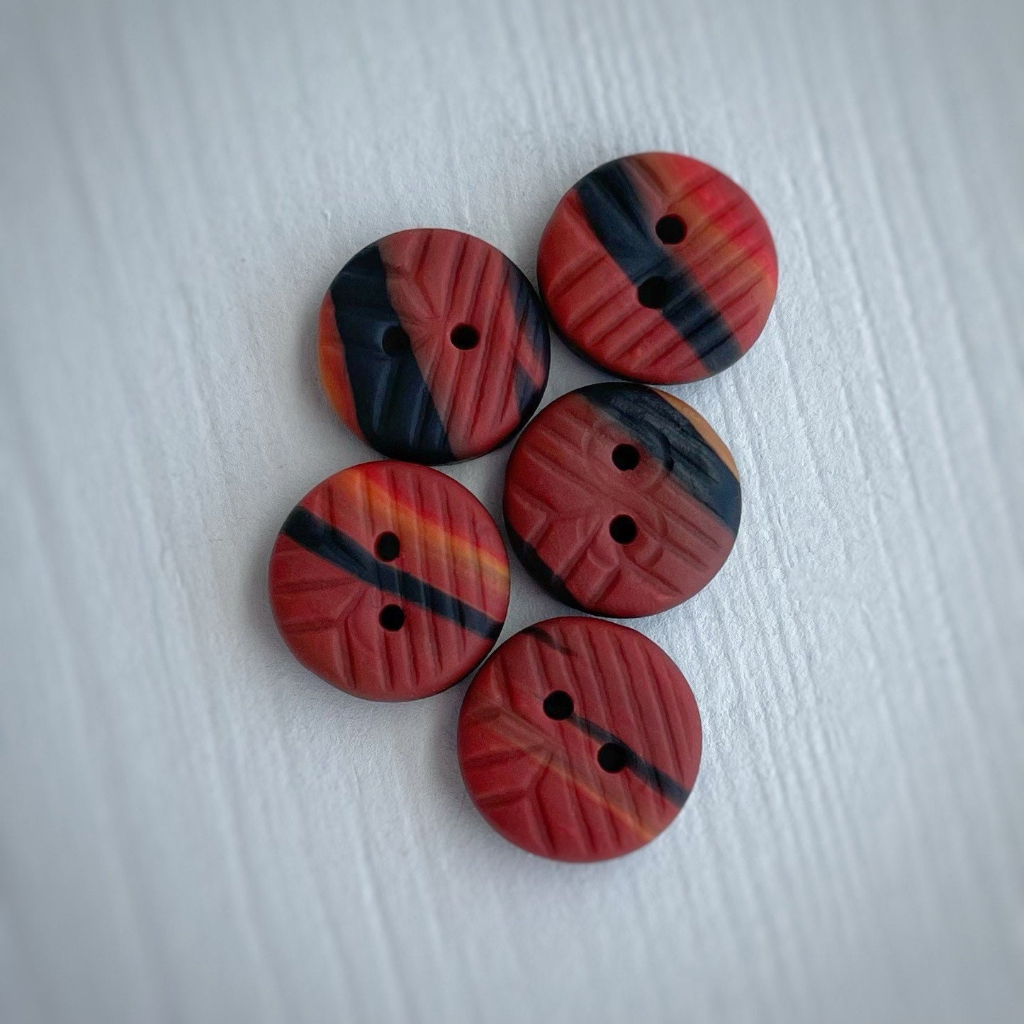 Small ~12mm Red, orange and black polymer clay buttons with impression - set of 5